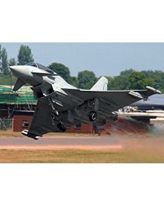 Eurofighter Typhoon jet taking off with smoke trail on a runway.