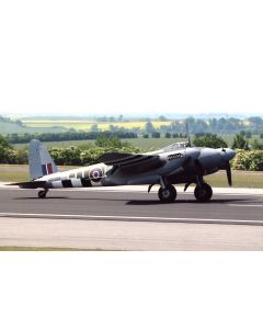 Classic British WWII aircraft taxiing on a runway, featuring distinctive black and white camouflage patterns and a recognizable tail design.