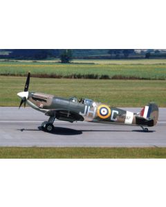 Vintage Supermarine Spitfire aircraft on the runway, featuring a camouflaged design, British roundel, and a clear sky background.