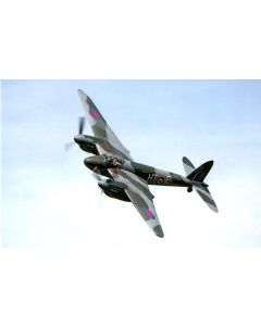 A vintage fighter plane flying against a clear blue sky, displaying a camouflage pattern and roundels on its wings.
