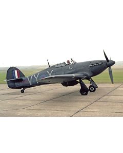 Historic Spitfire aircraft with British markings, taxiing on an airfield, showcasing its sleek design and propeller.