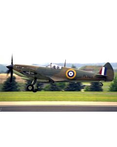 A vintage Supermarine Spitfire aircraft taking off on a runway, featuring roundel markings and a green camouflage paint scheme.