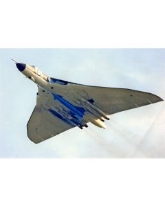 A sleek, delta-wing jet aircraft with blue accents is captured in flight against a cloudy sky, showcasing its unique aerodynamic design and military features.