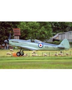 Vintage Royal Navy aircraft taking off over a grassy field with sheep in the background.