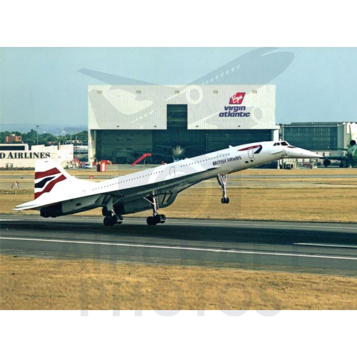 British Airways Concorde taking off in front of a Virgin Atlantic hangar at the airport.