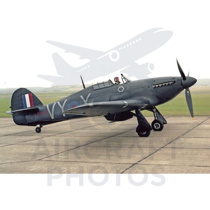 Historic Spitfire aircraft with British markings, taxiing on an airfield, showcasing its sleek design and propeller.