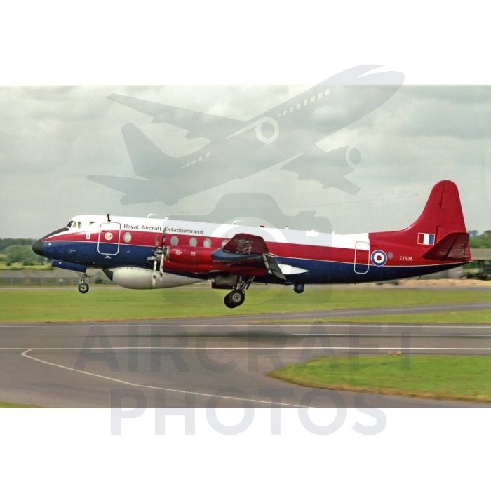 Royal Aircraft Establishment aircraft XT575 taking off, featuring a red and blue design, on a grassy runway under a cloudy sky.